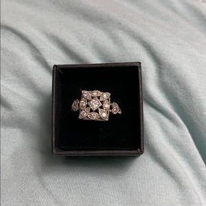 Silver with cubic zirconia accents.